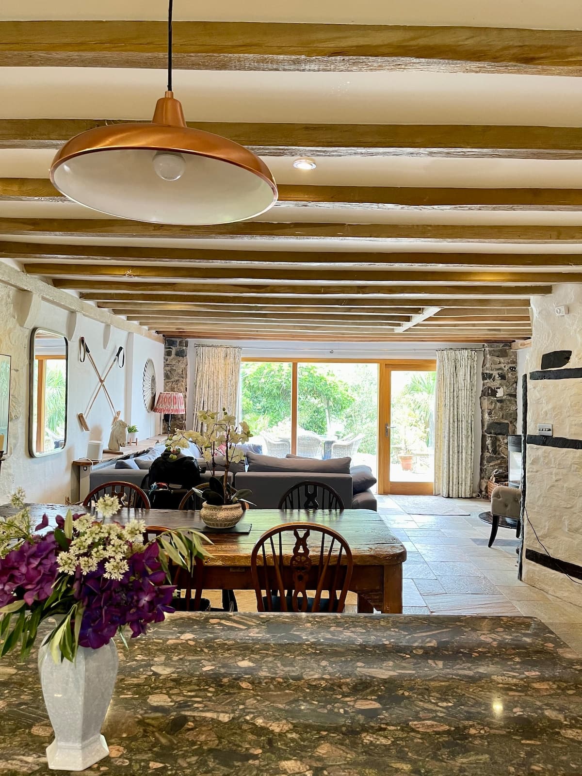 Light-filled dining space with original beams and garden views.