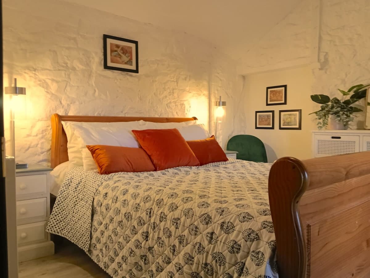 Restful nights in a cozy queen bedroom with warm layered bedding.